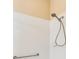Shower with a chrome shower head, chrome grab bar, and white tiled walls at 2376 Palm Tree Dr, Kissimmee, FL 34759
