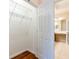 Spacious walk-in closet leading to the bathroom and featuring wood floors and wire shelving at 2376 Palm Tree Dr, Kissimmee, FL 34759