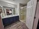 Bathroom with double vanity and glass-enclosed shower at 2531 Old Kent Cir, Kissimmee, FL 34758