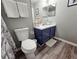 Well-lit bathroom featuring a vanity with blue cabinet, toilet and modern fixtures at 2531 Old Kent Cir, Kissimmee, FL 34758