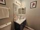 Bright bathroom with vanity, neutral paint, and decorative art at 2531 Old Kent Cir, Kissimmee, FL 34758