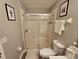 Bathroom with glass enclosed shower, updated fixtures, and decorative wall art at 2531 Old Kent Cir, Kissimmee, FL 34758