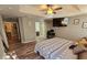 Large bedroom with a TV, wood floors, and a view into the bathroom at 2531 Old Kent Cir, Kissimmee, FL 34758