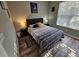 Bedroom with a queen bed, matching end tables, and natural light from the window at 2531 Old Kent Cir, Kissimmee, FL 34758