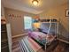 Bedroom with a bunk bed, colorful bedding, and natural light from the window at 2531 Old Kent Cir, Kissimmee, FL 34758
