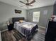 Comfortable bedroom with a ceiling fan, gray walls and a queen-size bed at 2531 Old Kent Cir, Kissimmee, FL 34758