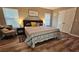 Comfortable bedroom with warm tones, wood-look floors, and a cozy sitting area at 2531 Old Kent Cir, Kissimmee, FL 34758