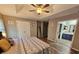 Bright bedroom featuring a tray ceiling, private bathroom, and wood-look floors at 2531 Old Kent Cir, Kissimmee, FL 34758