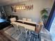 Dining area with a stylish table, comfortable seating, and a view of the living room at 2531 Old Kent Cir, Kissimmee, FL 34758