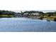 Picturesque community buildings and lake with foot bridge at 2531 Old Kent Cir, Kissimmee, FL 34758