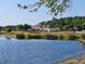Scenic view of community clubhouse and lake on a clear day at 2531 Old Kent Cir, Kissimmee, FL 34758