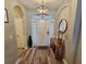 Welcoming foyer with wood-look flooring, elegant lighting, console table and decorative mirror at 2531 Old Kent Cir, Kissimmee, FL 34758