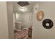 A neutral-toned hallway with art on the wall and wood-look floors at 2531 Old Kent Cir, Kissimmee, FL 34758