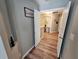 Hallway with wood-look floors and doorways leading to different rooms at 2531 Old Kent Cir, Kissimmee, FL 34758