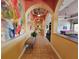 Well-lit hallway featuring decorative arches and a view of community game room at 2531 Old Kent Cir, Kissimmee, FL 34758