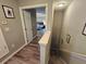 Upstairs hallway leading to carpeted staircase and a view into the Primary bedroom at 2531 Old Kent Cir, Kissimmee, FL 34758