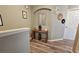 Hallway with wooden floor and a wooden table with a mirror above it at 2531 Old Kent Cir, Kissimmee, FL 34758