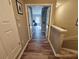Hallway leading to a bedroom with wood-look floors at 2531 Old Kent Cir, Kissimmee, FL 34758