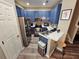 Bright kitchen features stainless steel appliances, stool and white countertops at 2531 Old Kent Cir, Kissimmee, FL 34758