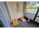 Screened patio with lake view, cornhole game, and neutral color scheme at 2531 Old Kent Cir, Kissimmee, FL 34758