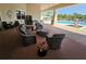 Inviting outdoor lounge area with comfortable seating and views of the pool and landscaping at 2531 Old Kent Cir, Kissimmee, FL 34758