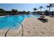 Inviting community pool with a fountain, surrounded by palm trees and lounge chairs at 2531 Old Kent Cir, Kissimmee, FL 34758