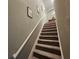 Stairs with carpet and a white railing leading to the upper floor at 2531 Old Kent Cir, Kissimmee, FL 34758