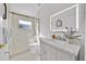 Bright bathroom featuring a marble vanity, an illuminated mirror, and a glass-enclosed shower at 2642 Gild Dust Cir., Kissimmee, FL 34744