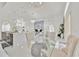 Elegant dining room featuring a glass table, chandelier, and views into the living space at 2642 Gild Dust Cir., Kissimmee, FL 34744