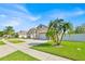 Well-manicured lawn with palms accentuates this beautiful home and its two-car garage at 2642 Gild Dust Cir., Kissimmee, FL 34744