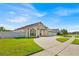Beautiful single-story home featuring a well-manicured lawn and an attached two-car garage at 2642 Gild Dust Cir., Kissimmee, FL 34744