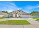 Charming single-story home boasts well-maintained lawn, arched entryway, and a two-car garage at 2642 Gild Dust Cir., Kissimmee, FL 34744