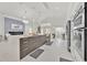 Modern kitchen with stainless steel appliances, center island and view into the living space at 2642 Gild Dust Cir., Kissimmee, FL 34744