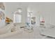 Bright living room features vaulted ceilings, crystal chandeliers, and luxurious white furniture at 2642 Gild Dust Cir., Kissimmee, FL 34744