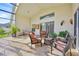 The tiled lanai features comfortable seating and views of the private yard at 2642 Gild Dust Cir., Kissimmee, FL 34744