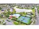 Aerial view of the community featuring a pool, tennis courts, basketball courts, and a lake at 2650 Patrician Cir, Kissimmee, FL 34746