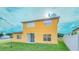 Bright yellow, two-story home with a sliding glass door and a well-maintained lawn at 2650 Patrician Cir, Kissimmee, FL 34746