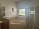 Elegant bathroom with a corner tub, glass-enclosed shower, and stylish fixtures at 2650 Patrician Cir, Kissimmee, FL 34746