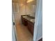 Bathroom features double vanity with a large mirror and tiled floors at 2650 Patrician Cir, Kissimmee, FL 34746