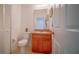 Half bathroom featuring a vanity, toilet, and tiled flooring at 2650 Patrician Cir, Kissimmee, FL 34746