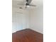 Bedroom featuring hardwood floors, ceiling fan, and a closet at 2650 Patrician Cir, Kissimmee, FL 34746
