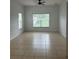 Neutral bedroom featuring tile floors and a sun-lit window at 2650 Patrician Cir, Kissimmee, FL 34746