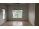 Neutral bedroom featuring tile floors and a sun-lit window at 2650 Patrician Cir, Kissimmee, FL 34746