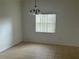 Simple dining room with tile flooring, classic chandelier, and natural light at 2650 Patrician Cir, Kissimmee, FL 34746
