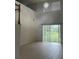 Open-concept living room featuring high ceilings and a glass sliding door at 2650 Patrician Cir, Kissimmee, FL 34746