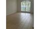 Bright living room with large window view and tile floors at 2650 Patrician Cir, Kissimmee, FL 34746