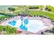 Community pool with lounge chairs, palm trees, and shade at 2650 Patrician Cir, Kissimmee, FL 34746