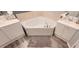 Bright bathroom featuring a corner tub and and vanities at 2729 Club Cortile Cir, Kissimmee, FL 34746