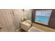 Bright bathroom with a large window, vanity with counter, and soaking tub at 2729 Club Cortile Cir, Kissimmee, FL 34746