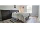 Bedroom with a large bed, window with blinds, and dresser at 2729 Club Cortile Cir, Kissimmee, FL 34746